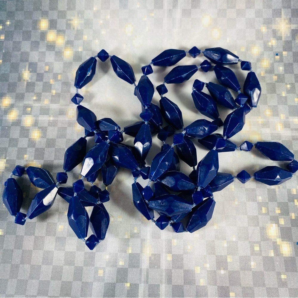Very cool vintage long strand of geometric shaped plastic beads. Hong Kong 48”